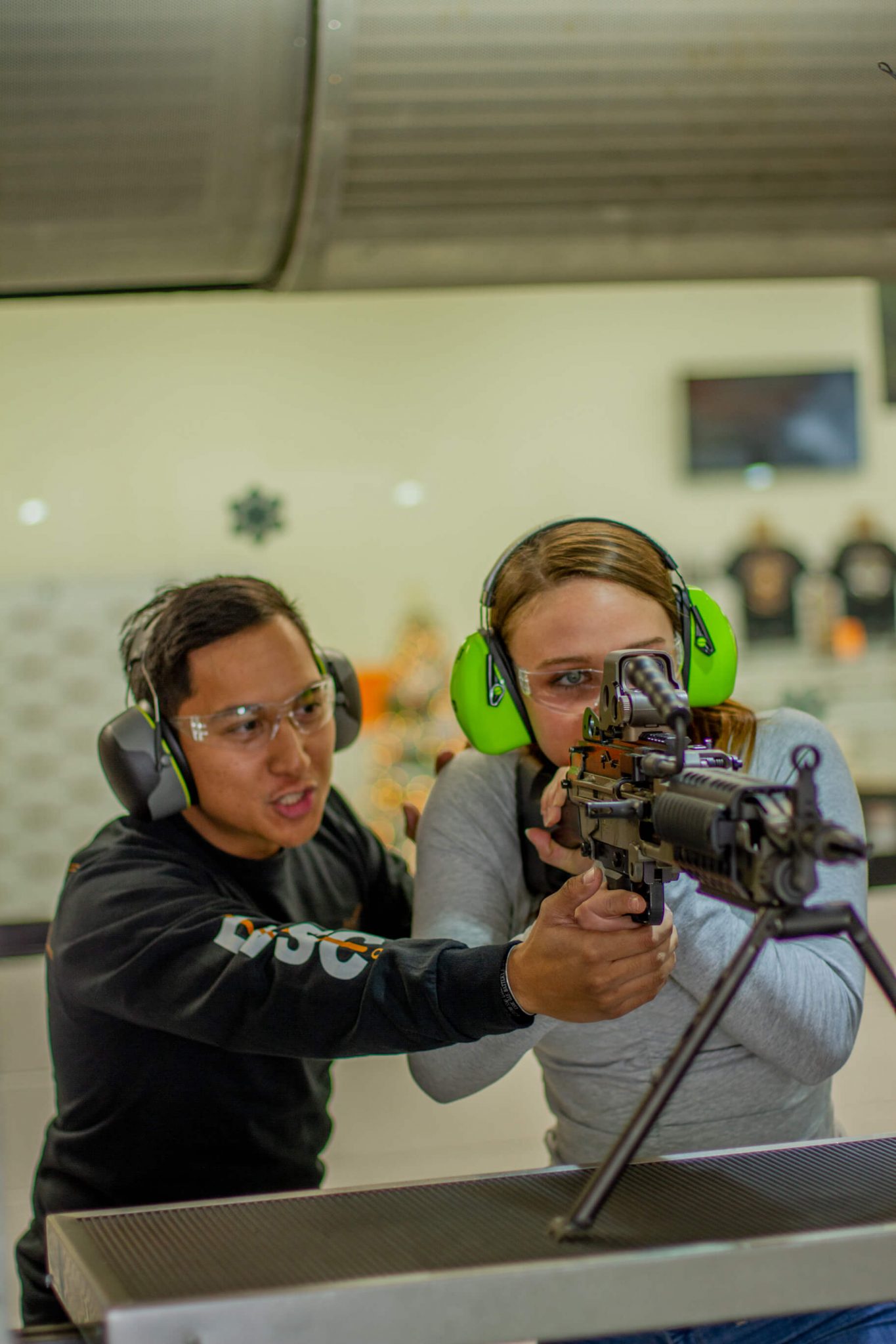 Man and Woman shooting assault rifle