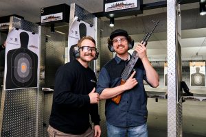 Men smiling at Las Vegas indoor shooting range